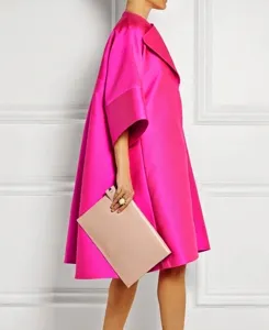 Vista laterale dell'abito in raso fucsia con rever e silhouette oversize