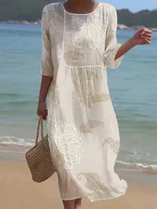 Detail view of white long dress featuring elegant floral print, round neck and mid-sleeves.