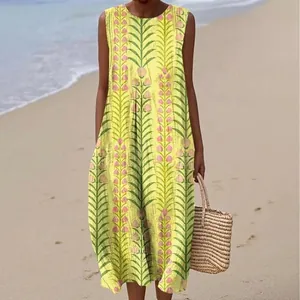 Detailed view of yellow sleeveless maxi dress with botanical floral print on beach