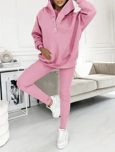 Detail of pink 3-piece tracksuit featuring a hooded sweatshirt and ribbed leggings.