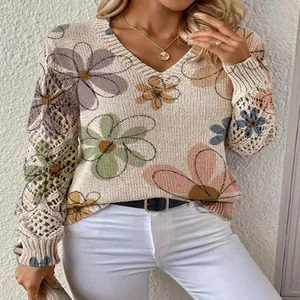 Detail of the V-neck sweater showing the floral print and crochet hollow-out sleeves