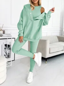 Close-up of mint green three-piece women's sportswear set with ribbed texture