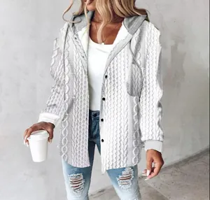 Detailed view of white cable-knit women's hoodie jacket with grey hood and pocket