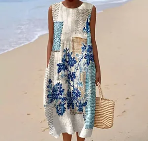 Elegant detail view of a sleeveless blue floral print maxi dress with a beach background
