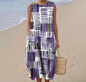 Sleeveless maxi dress detail featuring purple abstract patterns on a sunny beach