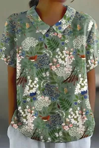 Detail showing the floral bird print and lapel collar of this loose casual women's blouse.