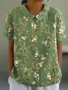 Detailed macro view of women's loose floral print top with a classic turnover collar