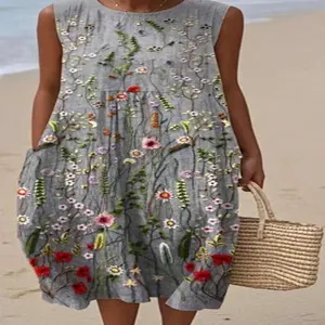 Detailed view of grey sleeveless dress with vibrant floral embroidery and functional pockets