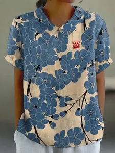 Close-up of a women's loose casual short-sleeved top with blue floral print and lapel