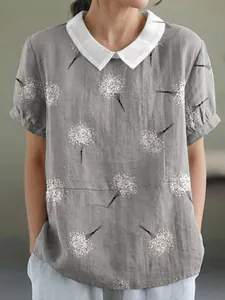 Close-up of women's grey short sleeve blouse with white dandelion print and collar