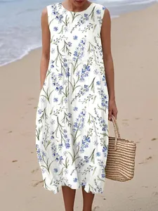 Detailed view of white sleeveless maxi dress featuring blue floral print and side pocket