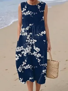 Navy blue sleeveless midi dress with white floral print for a casual beach look.