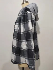 Side profile of women's casual black and white plaid jacket with a grey fleece hood