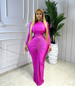Close-up view of elegant fuchsia ruched long-sleeved crop top and matching maxi skirt set