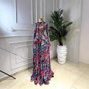 Detail view of a long-sleeved mesh maxi dress with vibrant tie-dye print pattern
