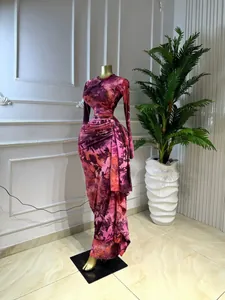 Elegant pink and purple floral print long-sleeved pleated maxi dress on a gold mannequin.
