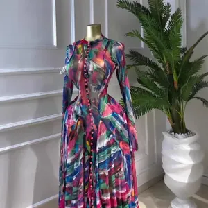 Detailed view of a vibrant colorful tie-dye mesh maxi dress displayed on a gold mannequin
