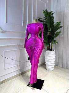 Elegant magenta two-piece set featuring long-sleeved top and ruched maxi skirt