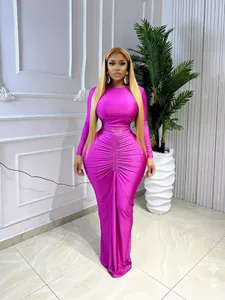 Magenta two-piece fashion set with long-sleeved crop top and elegant ruched maxi skirt