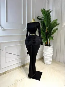 Elegant two-piece set featuring long-sleeved crop top and ruched maxi skirt in black