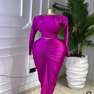 Elegant magenta two-piece set featuring a long-sleeved top and a high-waisted ruched skirt
