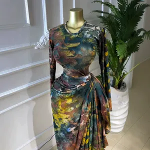 Detailed view of the abstract print and elegant pleated draping on long sleeve gown