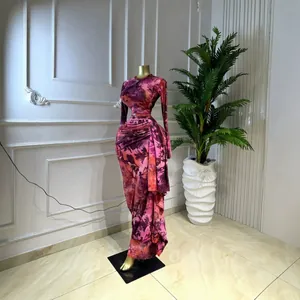 Detailed view showing the intricate pleats of a purple printed long sleeve maxi dress