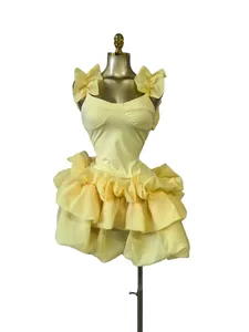 Pale yellow sleeveless bubble mini dress with tiered ruffles on mannequin