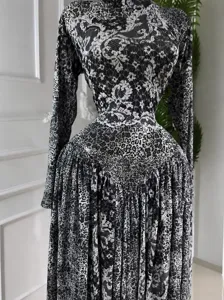 Elegant long sleeve maxi dress with leopard and floral lace print pattern on mannequin