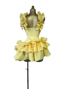 Detail view of a sweet yellow mini dress featuring voluminous ruffles and sleeveless design