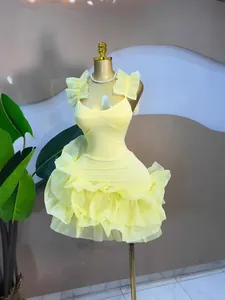 Elegant pale yellow ruffle mini dress with sweetheart neckline and tiered bubble skirt