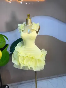 Detailed view of the layered yellow mesh ruffles on a sweet style sleeveless mini dress.