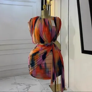 Detail of sleeveless tie-dye print two-piece set with pleated top and draped skirt.