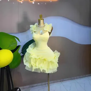 Detail view of a sweet yellow mini dress with multi-layered ruffles and sleeveless design