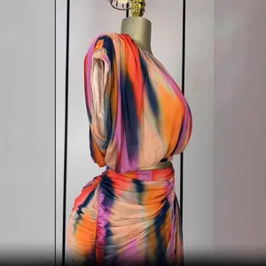 Detail of sleeveless ruched tie-dye top and skirt set in vibrant summer colors