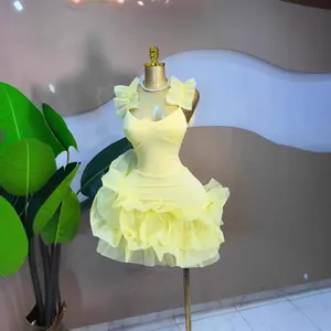 Sweet yellow sleeveless ruffled mini dress with layered tulle bubble skirt on mannequin display