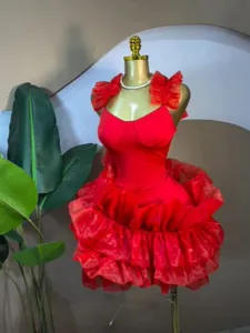 Red sleeveless ruffled bubble hem mini dress displayed on a professional golden mannequin