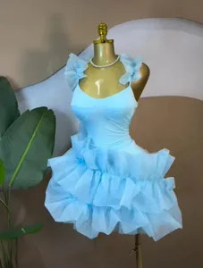 Light blue tiered ruffle mini dress with straps on mannequin for sweet elegant look.
