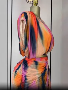 Colorful tie-dye sleeveless top and pleated mini skirt two-piece set on a mannequin