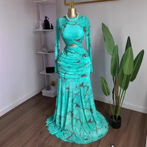 Close-up of the pleated mesh fabric and marble print on this elegant turquoise gown