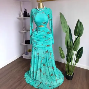 Full-length view of a turquoise marble print mermaid dress with waist cut-out design.