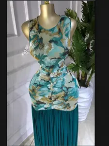 Detail view of sleeveless tie-dye print dress with a pleated teal skirt on mannequin