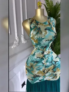 Detailed view of the sleeveless tie-dye print dress with ruched waist and pleated hem.