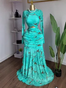 Turquoise mesh long sleeve mermaid dress with ruched cut-out detail and print.