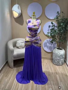 Detailed view of sleeveless tie-dye maxi dress with purple pleated skirt patchwork