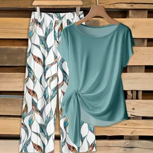 Women's 2-piece set with teal twist front top and printed wide leg pants details
