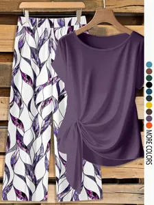 Detail of purple short-sleeve knot top and patterned wide-leg pants coordinates set.