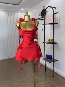 Red mini dress on mannequin featuring exquisite 3D floral accents and elegant straps.