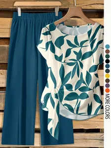 Detail view of women's leaf print short sleeve twist top and matching wide leg pants.