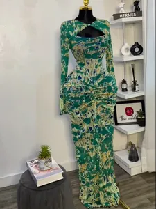 Detailed view of green printed long sleeve maxi dress with cutout and ruching